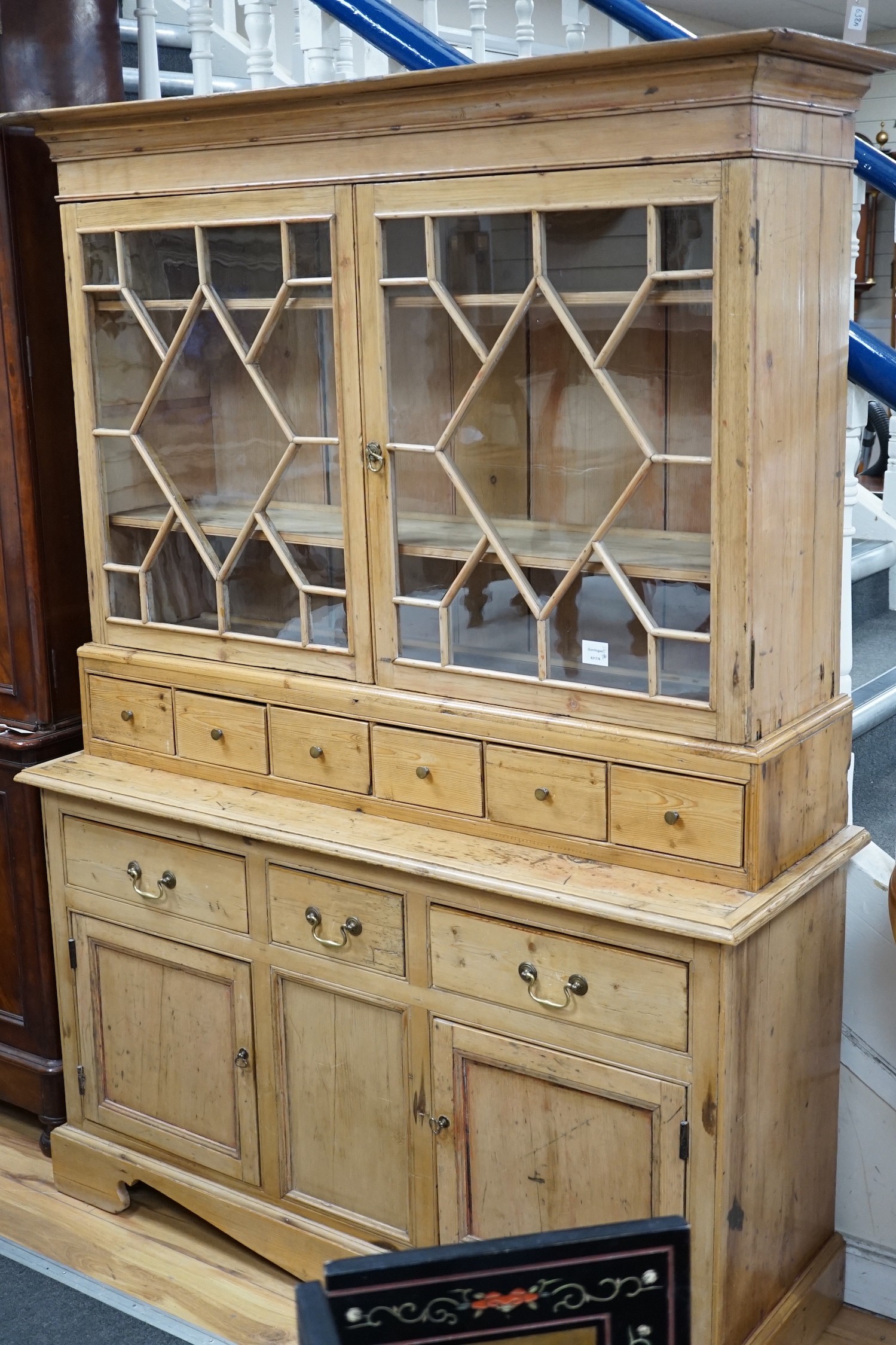 A 19th century pine dresser base of small proportions with an associated glazed cabinet top, width 133cm, height 185cm *Please note the sale commences at 9am.